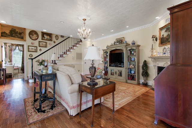 2460 Canopy Ln, Perry, FL 32347 - living area featuring stairs, a chandelier, crown molding, a fireplace, and wood finished floors