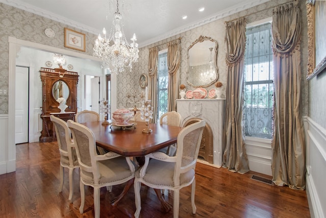2460 Canopy Ln, Perry, FL 32347 - dining area featuring wallpapered walls, a chandelier, crown molding, wood finished floors, and healthy amount of natural light