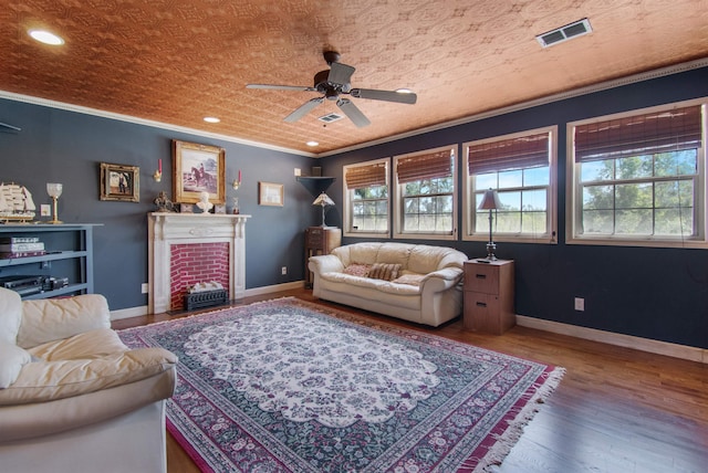 2460 Canopy Ln, Perry, FL 32347 - living room with ceiling fan, ornamental molding, a fireplace with flush hearth, wood finished floors, and baseboards
