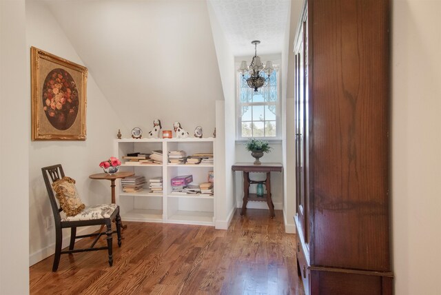 2460 Canopy Ln, Perry, FL 32347 - sitting room with wood finished floors, a chandelier, vaulted ceiling, and baseboards