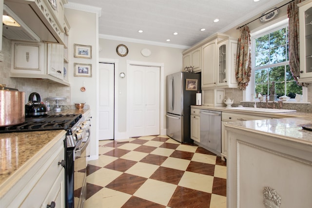 2460 Canopy Ln, Perry, FL 32347 - kitchen featuring appliances with stainless steel finishes, cream cabinets, light countertops, recessed lighting, and light floors