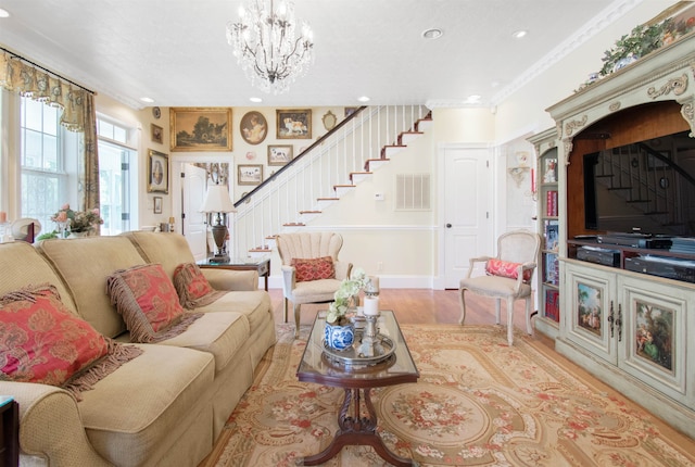 2460 Canopy Ln, Perry, FL 32347 - living area featuring stairs, wood finished floors, a chandelier, recessed lighting, and crown molding