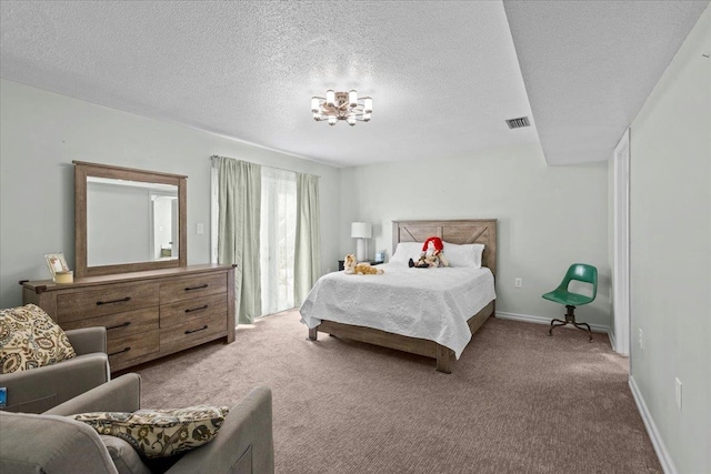 bedroom with carpet floors and a textured ceiling