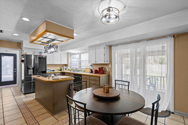 kitchen with white cabinetry, dishwasher, stainless steel fridge with ice dispenser, a textured ceiling, and a kitchen island