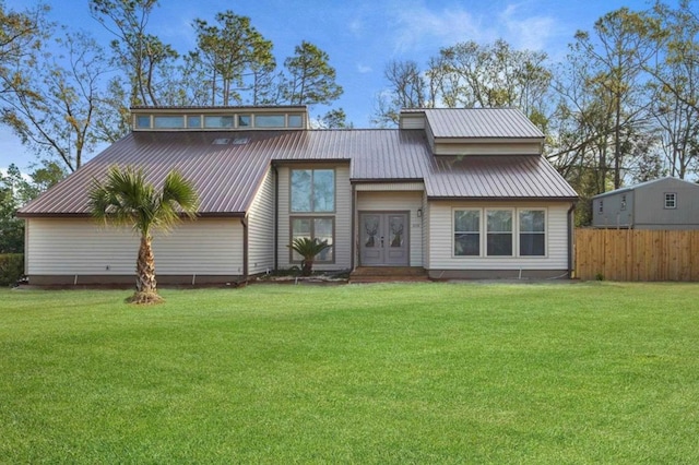 rear view of property featuring a yard and french doors