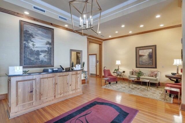 121 N Monroe St Unit 1103, Tallahassee, FL 32301 - living room featuring crown molding, light wood-type flooring, a chandelier, a raised ceiling, and recessed lighting