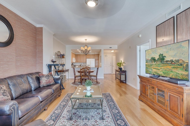 121 N Monroe St Unit 1103, Tallahassee, FL 32301 - living area featuring a chandelier, light wood finished floors, and ornamental molding
