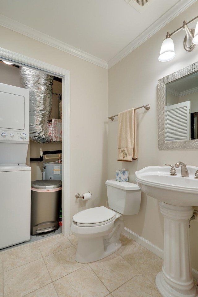 121 N Monroe St Unit 1103, Tallahassee, FL 32301 - bathroom with stacked washing machine and dryer, crown molding, and tile patterned flooring