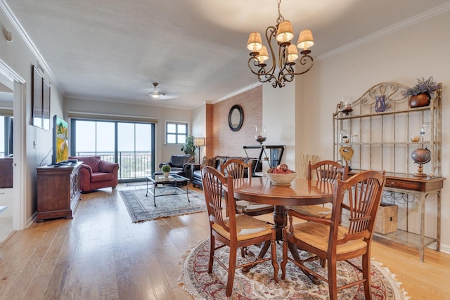121 N Monroe St Unit 1103, Tallahassee, FL 32301 - dining room featuring ornamental molding, light wood-style floors, a ceiling fan, and a chandelier