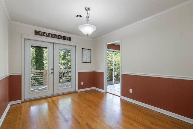 2307 Spoonwood Dr, Tallahassee, FL 32303 - unfurnished room with french doors, wood finished floors, baseboards, and ornamental molding