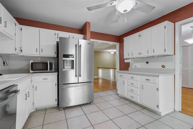 2307 Spoonwood Dr, Tallahassee, FL 32303 - kitchen featuring stainless steel appliances, a sink, light countertops, tasteful backsplash, and white cabinets