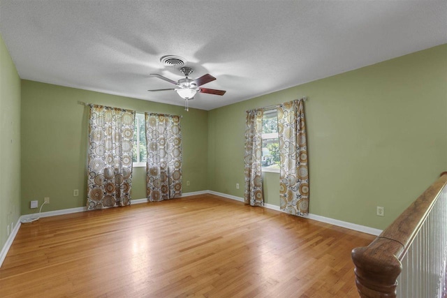 2307 Spoonwood Dr, Tallahassee, FL 32303 - spare room with a ceiling fan, wood finished floors, baseboards, and a textured ceiling