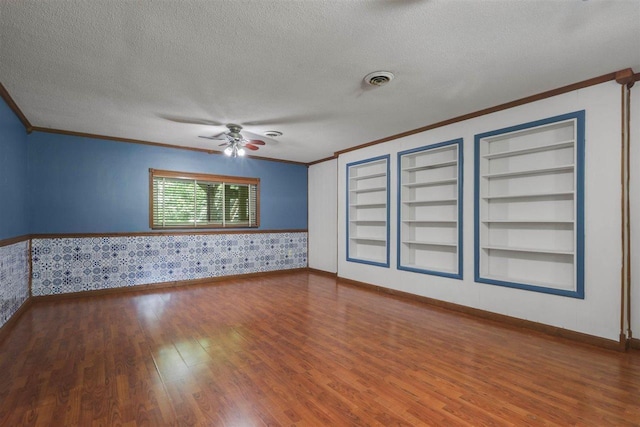 2307 Spoonwood Dr, Tallahassee, FL 32303 - spare room with crown molding, wood finished floors, ceiling fan, a textured ceiling, and built in features