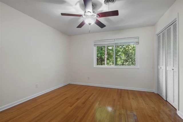 2307 Spoonwood Dr, Tallahassee, FL 32303 - unfurnished bedroom with hardwood / wood-style flooring, baseboards, a closet, and a ceiling fan