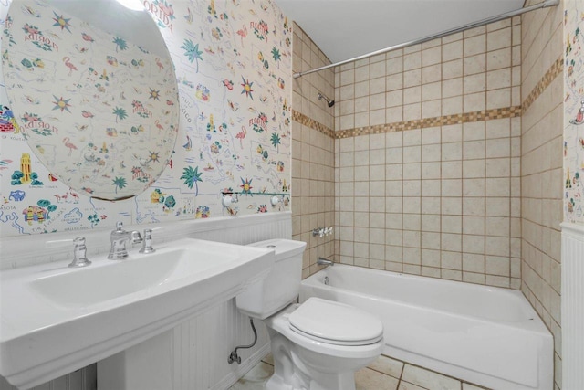 2307 Spoonwood Dr, Tallahassee, FL 32303 - full bathroom featuring bathing tub / shower combination, toilet, wallpapered walls, wainscoting, and tile patterned flooring