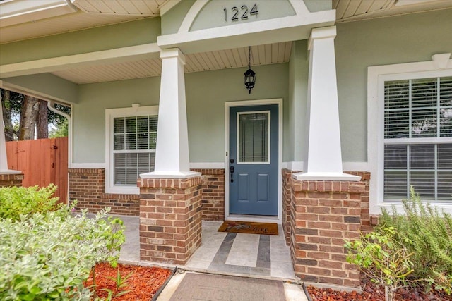 1224 Athens Ct, Tallahassee, FL 32305 - property entrance featuring brick siding, a porch, and stucco siding