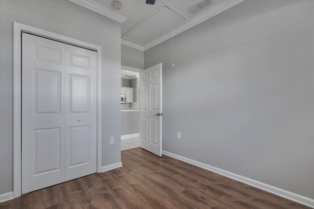 1224 Athens Ct, Tallahassee, FL 32305 - unfurnished bedroom with attic access, ornamental molding, dark wood-style floors, baseboards, and a closet