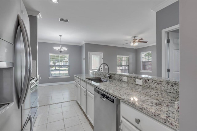 1224 Athens Ct, Tallahassee, FL 32305 - kitchen featuring appliances with stainless steel finishes, a sink, white cabinets, crown molding, and ceiling fan