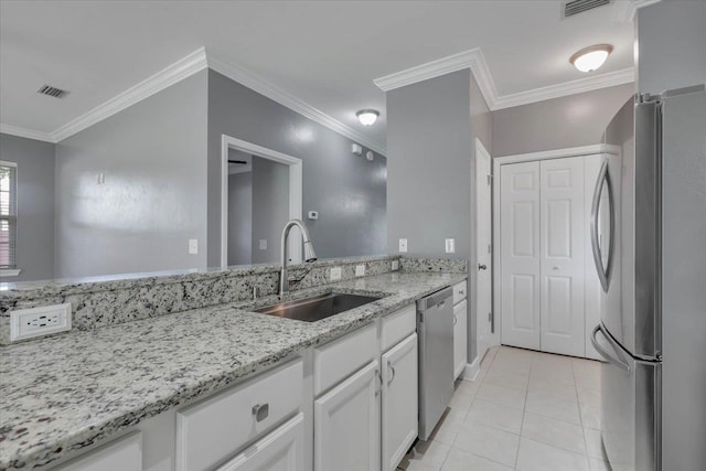 1224 Athens Ct, Tallahassee, FL 32305 - kitchen with stainless steel appliances, a sink, white cabinets, light tile patterned floors, and light stone counters