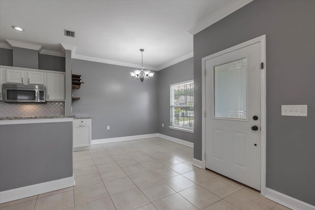 1224 Athens Ct, Tallahassee, FL 32305 - kitchen featuring stainless steel microwave, open shelves, ornamental molding, backsplash, and white cabinetry
