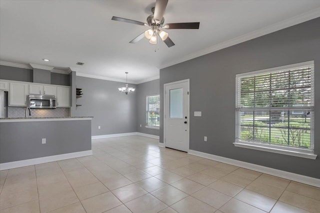 1224 Athens Ct, Tallahassee, FL 32305 - unfurnished living room with a chandelier, light tile patterned flooring, a ceiling fan, crown molding, and baseboards
