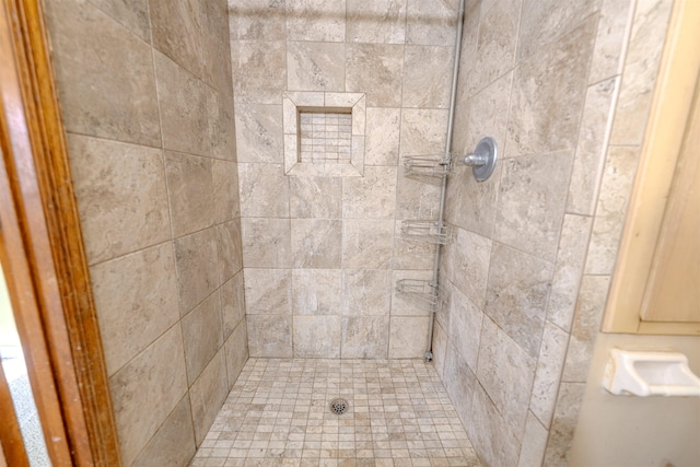 bathroom with tiled shower