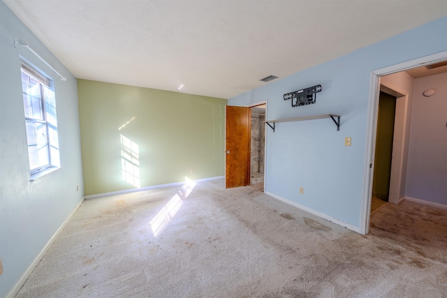 spare room featuring light colored carpet