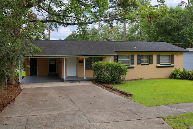 ranch-style house featuring a front yard and a carport