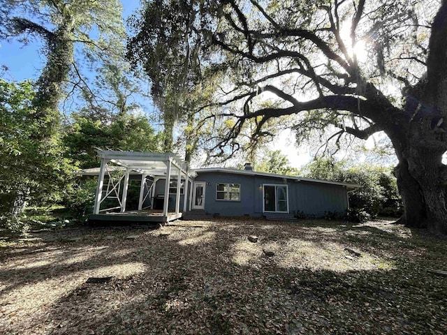 rear view of house with a pergola