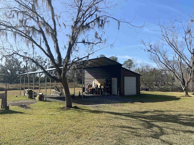 view of yard with a garage and an outbuilding