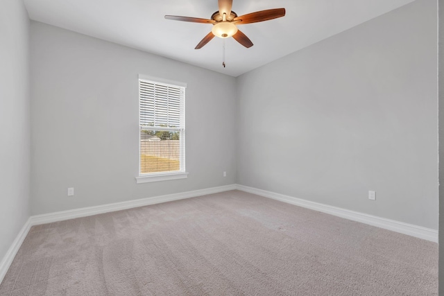 spare room with ceiling fan and carpet