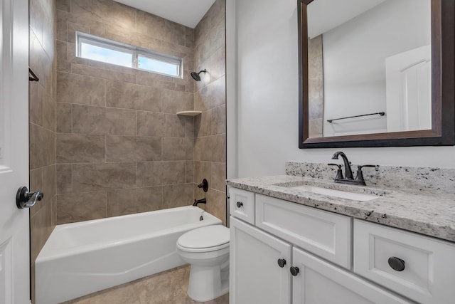 full bathroom with tile patterned floors, tiled shower / bath combo, toilet, and vanity