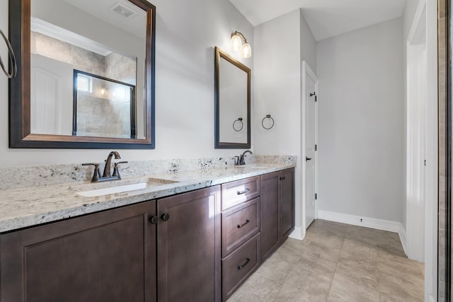 bathroom featuring vanity and a shower with shower door