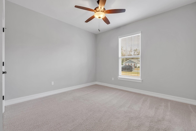 spare room featuring carpet flooring and ceiling fan