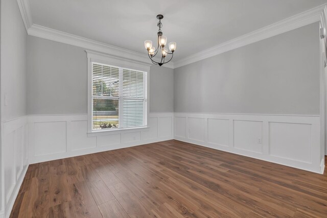 unfurnished room featuring crown molding, dark hardwood / wood-style flooring, and a chandelier