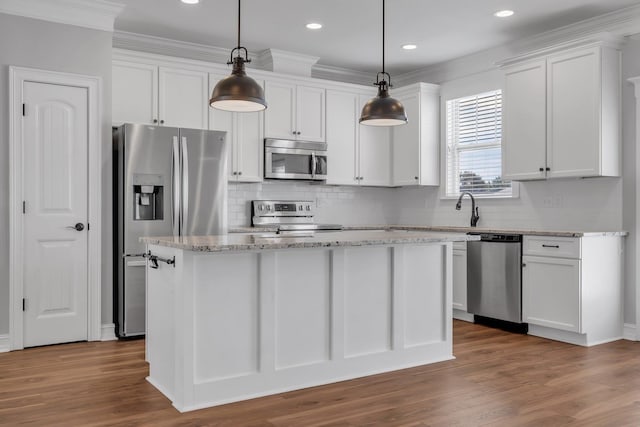 kitchen with white cabinets, appliances with stainless steel finishes, and hanging light fixtures