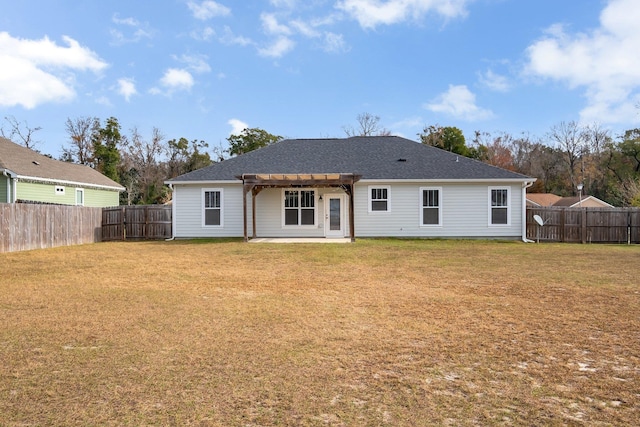 back of property with a pergola and a yard