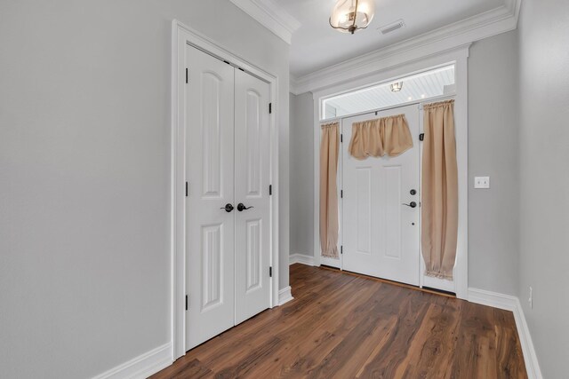 entrance foyer with dark hardwood / wood-style flooring and ornamental molding