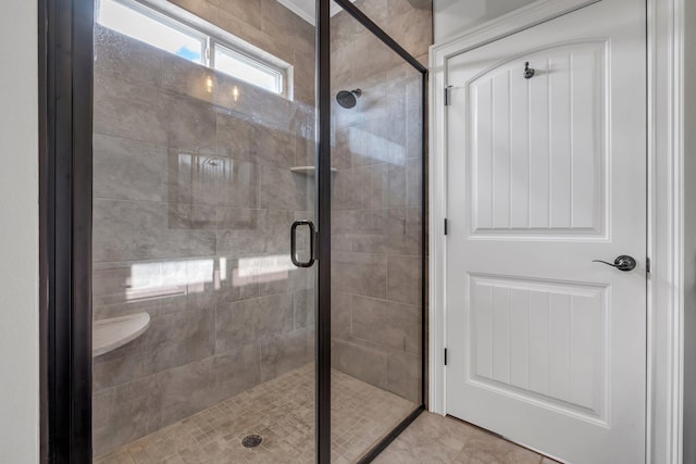 bathroom featuring tile patterned floors and an enclosed shower