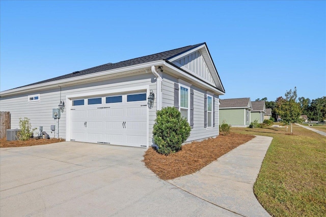 view of side of home with cooling unit and a garage