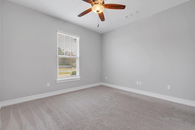 carpeted spare room with ceiling fan