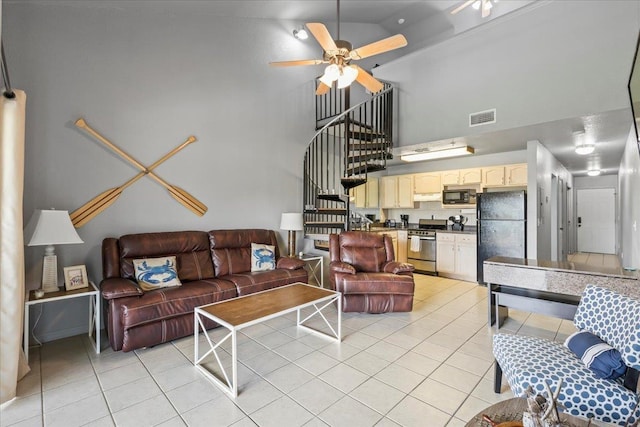 15 NW First St Unit 307, Steinhatchee, FL 32359 - living room featuring a towering ceiling, light tile patterned floors, ceiling fan, and stairs