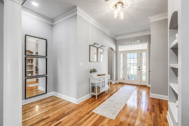 832 Eagle View Dr, Tallahassee, FL 32311 - foyer entrance featuring arched walkways, wood finished floors, ornamental molding, and baseboards