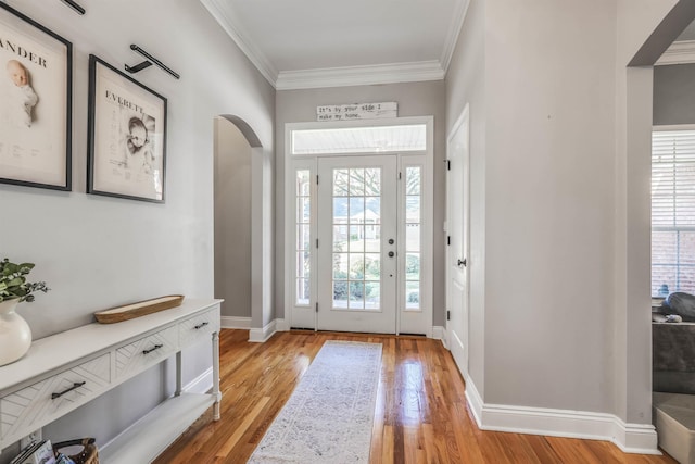 832 Eagle View Dr, Tallahassee, FL 32311 - foyer with light wood-type flooring, baseboards, arched walkways, and ornamental molding
