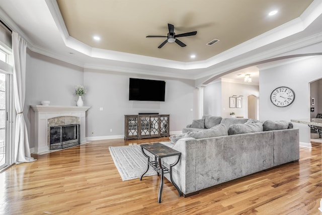 832 Eagle View Dr, Tallahassee, FL 32311 - living room with arched walkways, a raised ceiling, a ceiling fan, crown molding, and recessed lighting