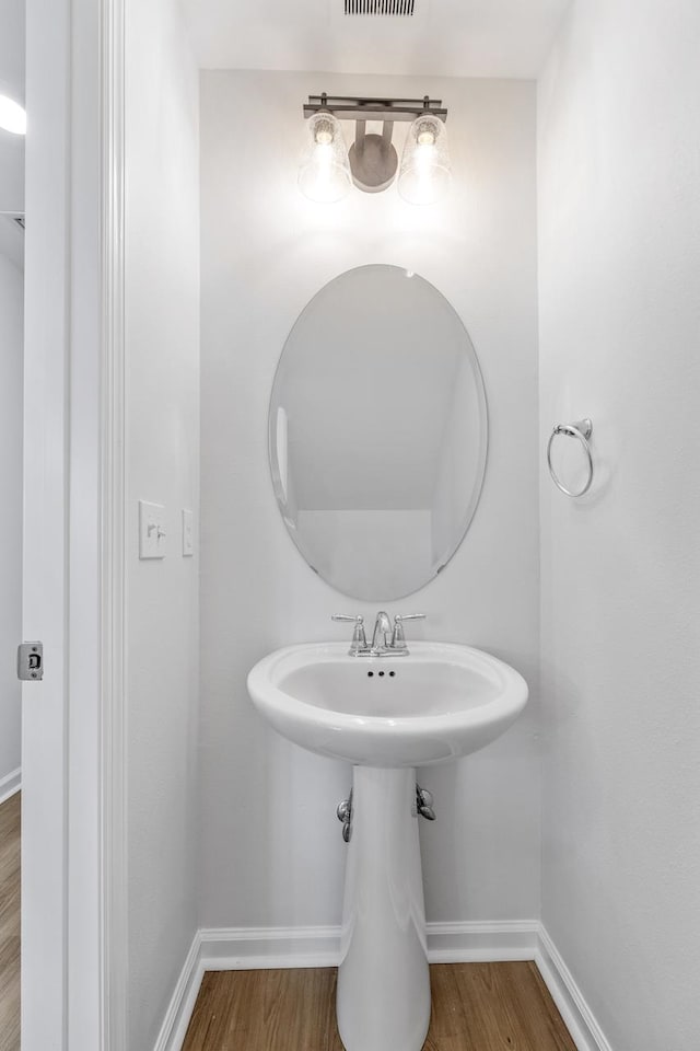 bathroom with hardwood / wood-style floors