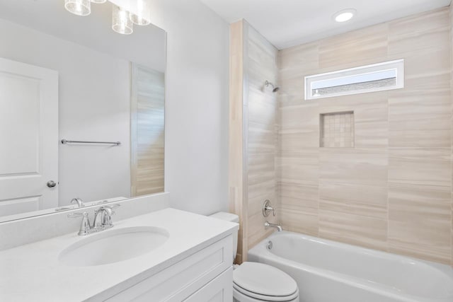 full bathroom featuring vanity, toilet, and tiled shower / bath