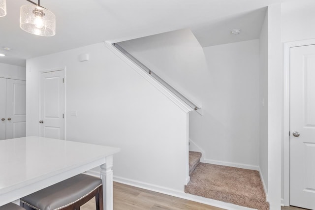 staircase with hardwood / wood-style floors