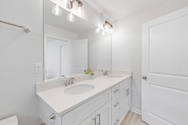 bathroom with hardwood / wood-style floors and vanity