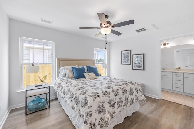 bedroom with ceiling fan, ensuite bathroom, and light hardwood / wood-style floors